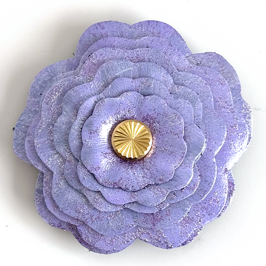 Lavender Sparkle flower-shaped object with a gold center on a white background