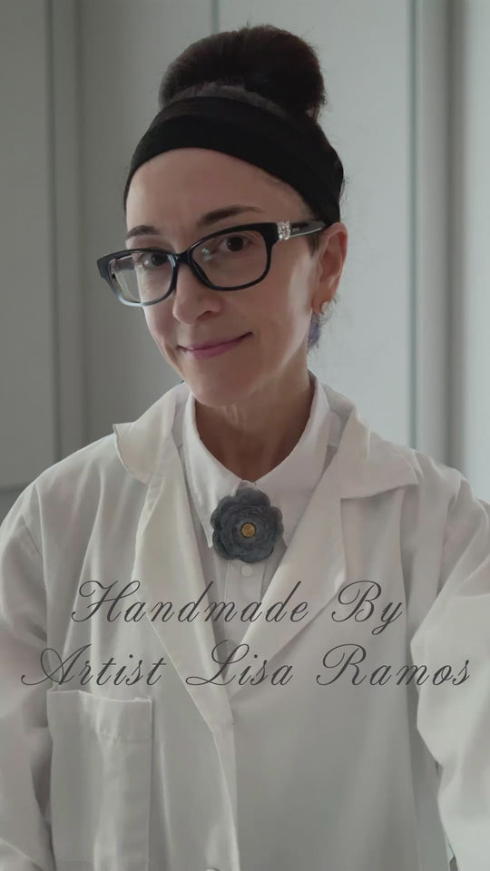 Artist Lisa Ramos Showing Her Handmade Leather Flower Magnetic Accessory