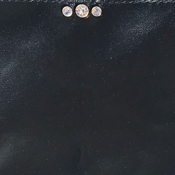 Three sparkling clear crystals mounted in gold hardware
