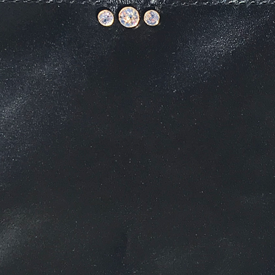 Three sparkling clear crystals mounted in gold hardware