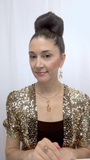 Designer, Lisa Ramos showcasing a the necklace in gold and matching earrings.  
